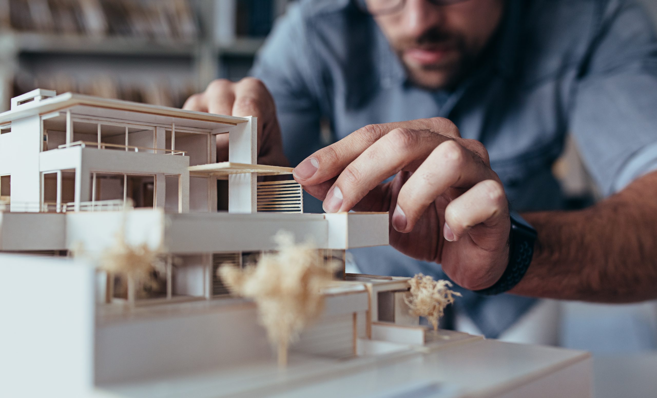 Close,Up,Of,Male,Architect,Hands,Making,Model,House.,Man